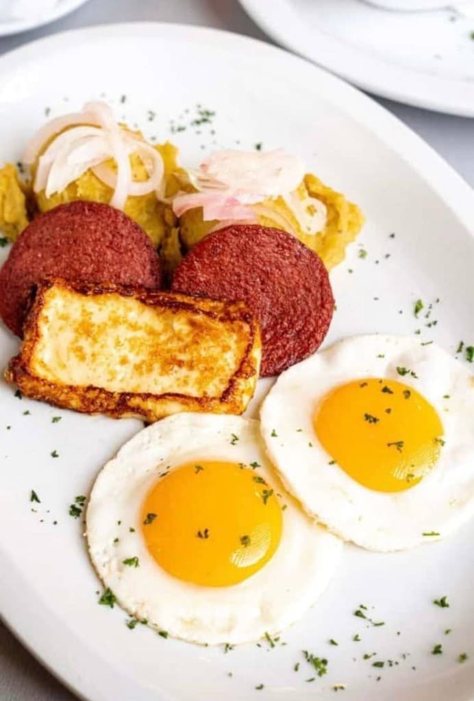 Traditional Dominican breakfast — mangú, eggs, fried cheese and salami
