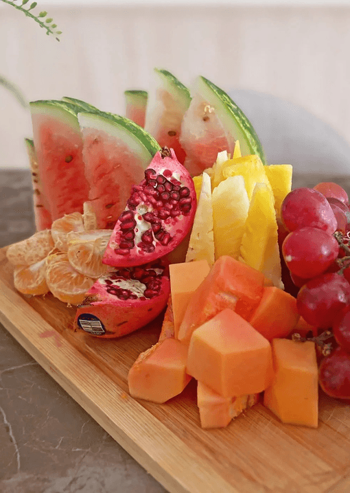 Seasonal fresh fruit platter on a wooden board
