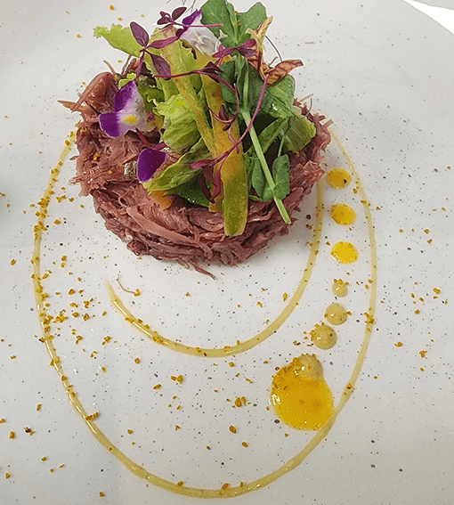 Shredded beef with microgreens and citrus oil