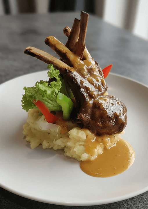 Lamb chops with mashed potatoes and herb garnish